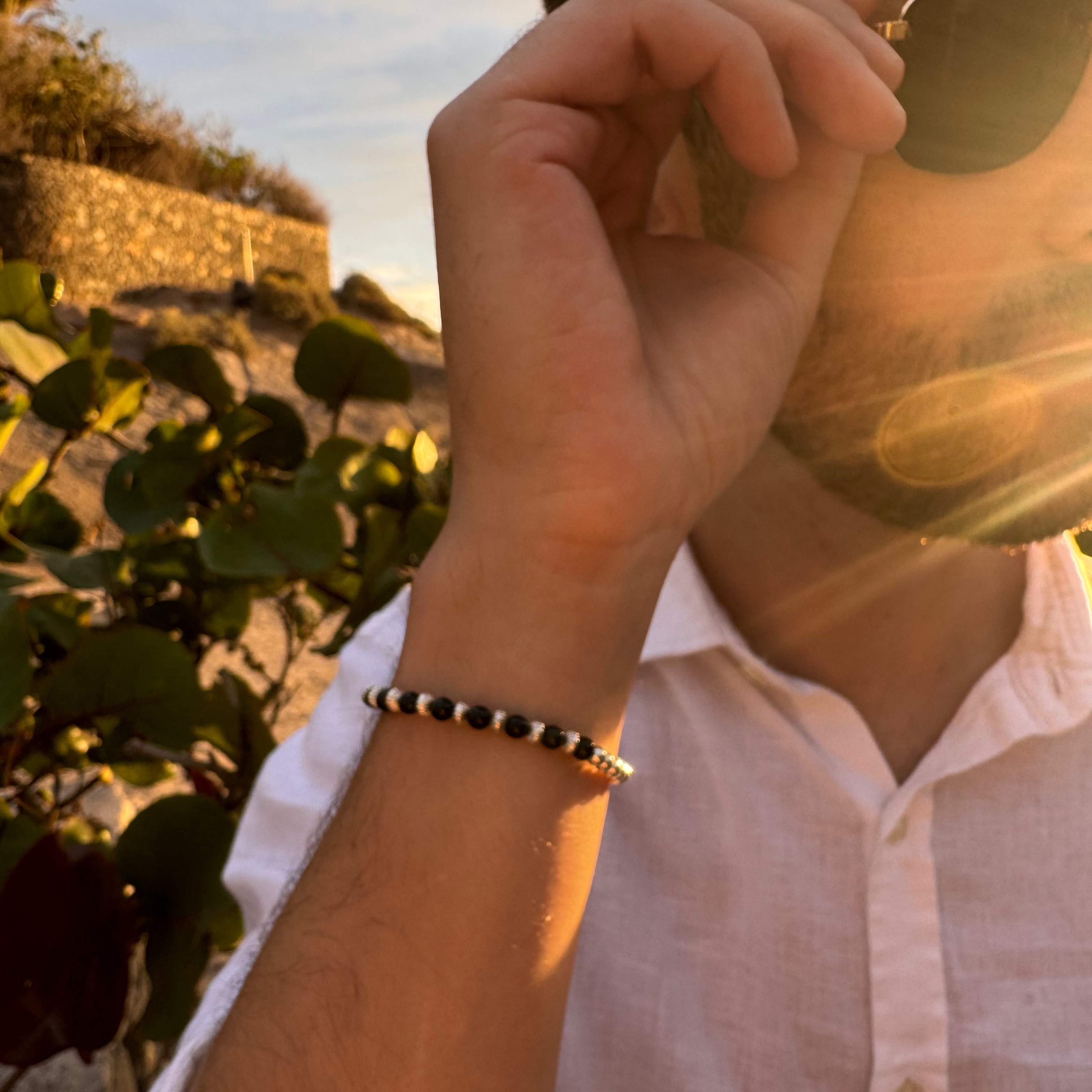 Man with sunglasses and bracelet