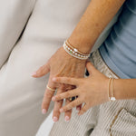 stack of silver and gold bracelets 