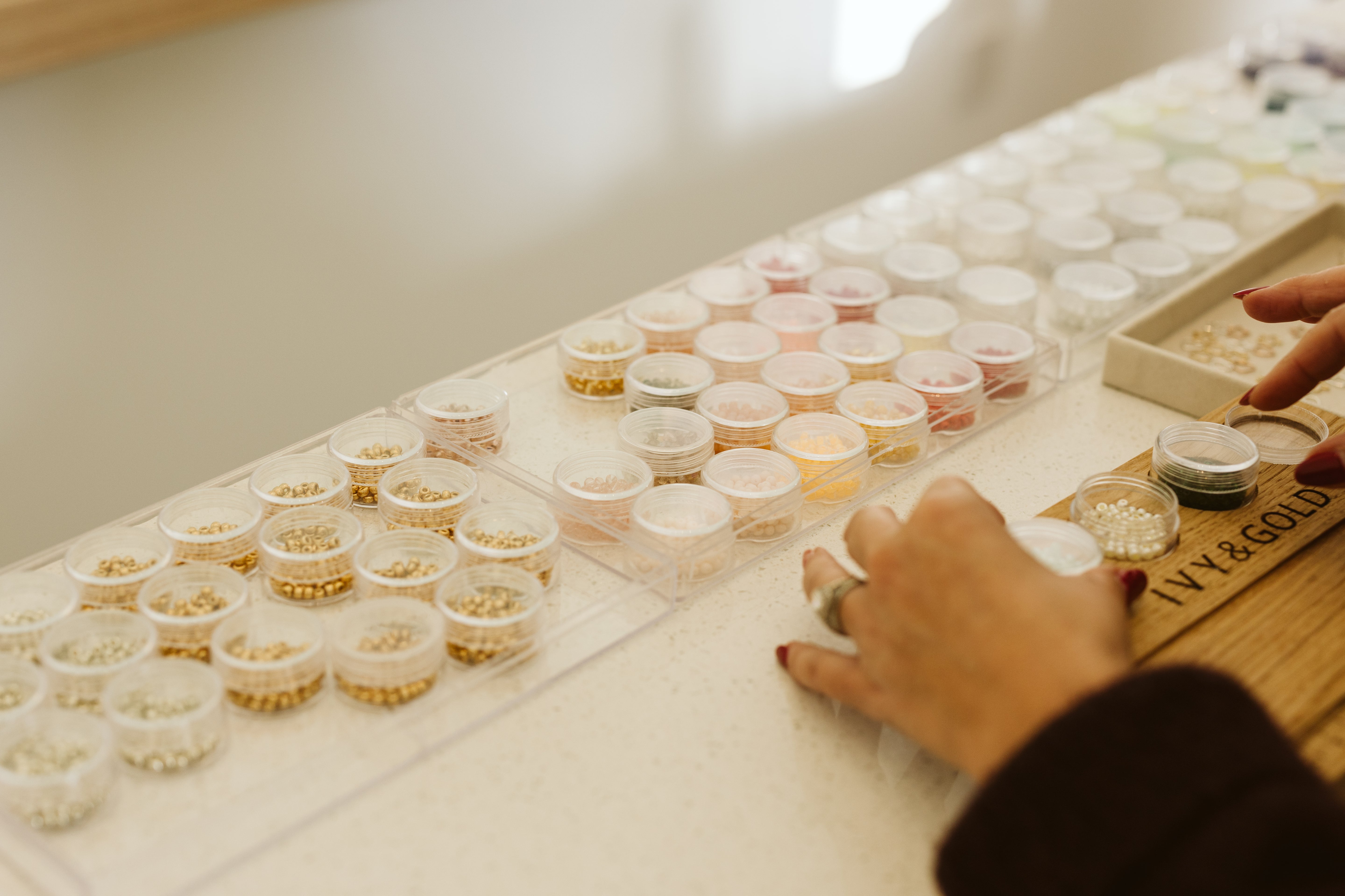 Pots of beads at the bead bar ivy and gold