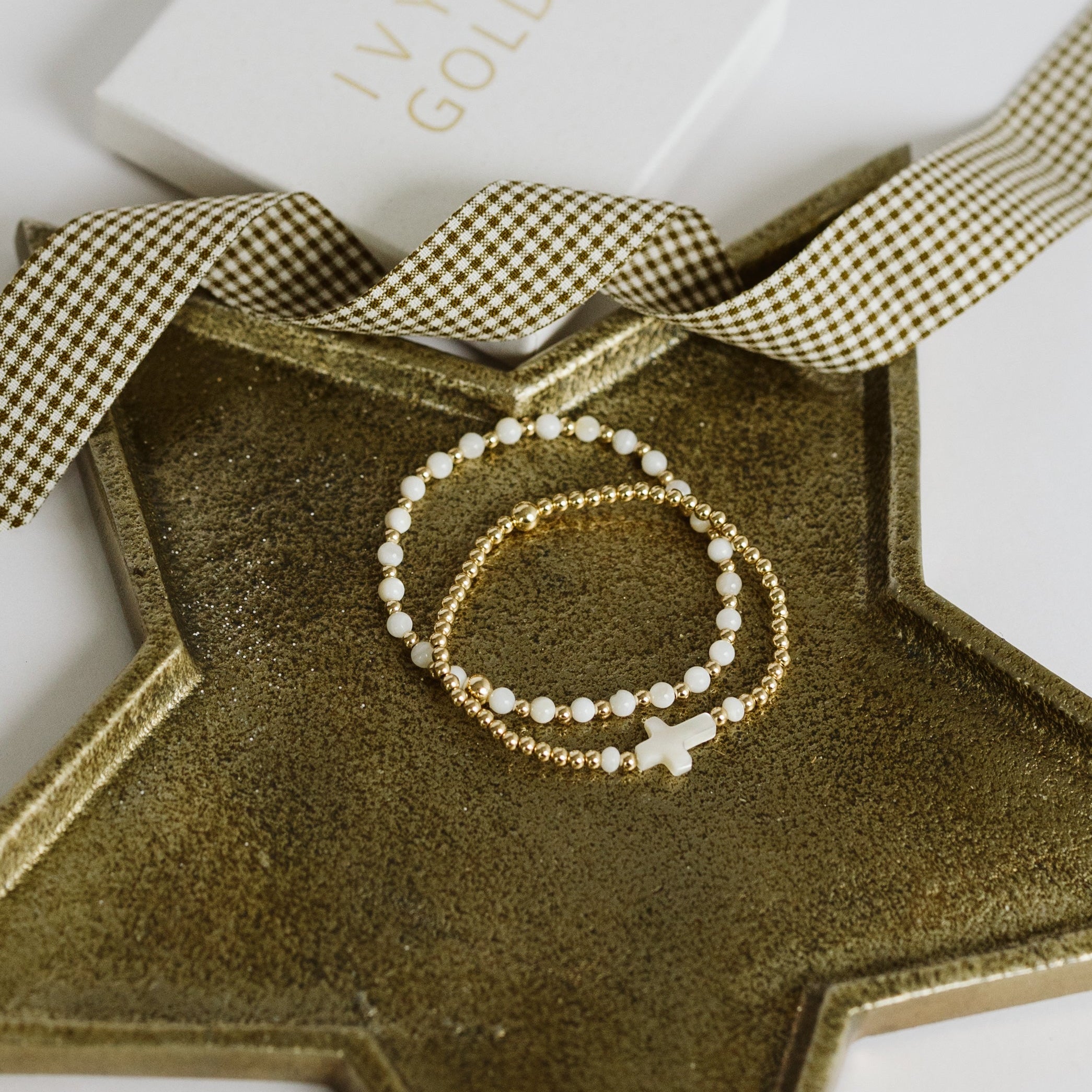 Pearl and gold bracelet with cross bead