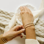 Gold and silver bracelets with yellow and green beads