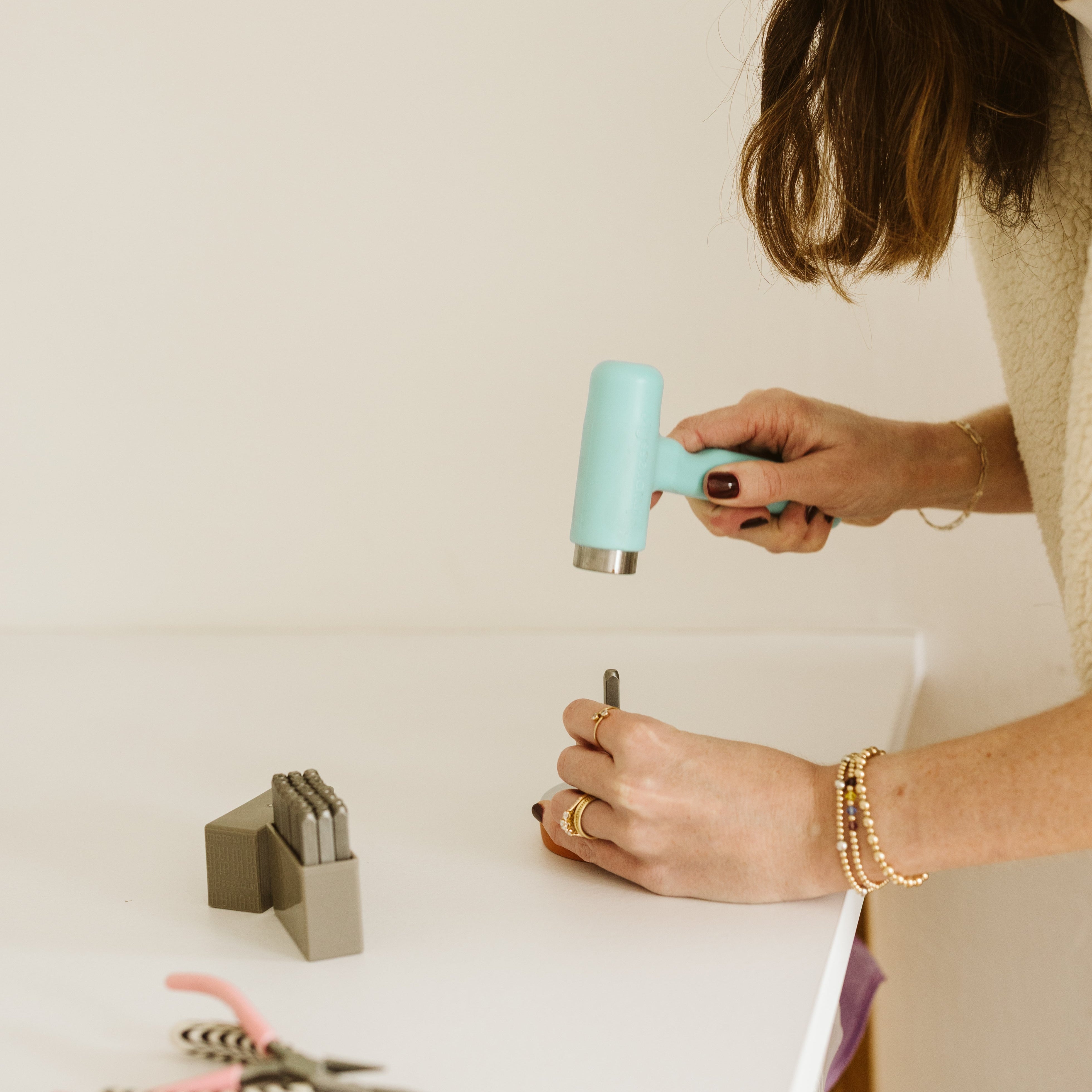 Erinn stamping the disc with an inital 