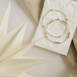 Mixed metal bracelets on a decorative plate
