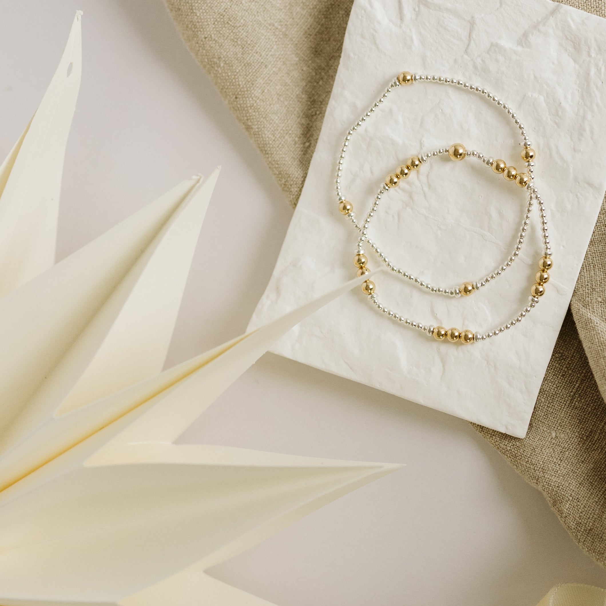 Mixed metal bracelets on a decorative plate
